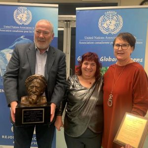 Tim Stainton, Rachelle Hole and Renata Shearer posing and holding an award